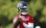 NFL Quarterback Faces Rocky Start in Training Camp Amid Team Tensions