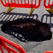 Giant Sinkhole Swallows Road in Westminster: Chaos as Emergency Crews Rush to Scene