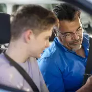 Dashcam Captures UK Driver's Bizarre Highway Stunt: Sitting on Open Boot Lid While Car Moves