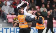 Gary Neville Branded 'Traitor' in Shocking Salford City Pitch Invasion Protest