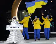 Russian Volunteer in Milan Carries Ukraine Placard at Winter Olympics Opening