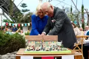 King Charles and Queen Camilla Share Laughter While Cutting Cake with Sword at Eden Project