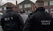 Armed Police Raid Homes in UK-French Crackdown on Major People Smuggling Ring