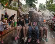 Global Snapshot: Water Fight in Laos and Coal-Fired Fiat Among Daily Photos