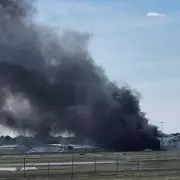Plane Crashes into Hangar at Adelaide Airport, Thick Smoke Fills Sky