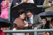 Racegoers Brave Rain and Hail at Aintree Ahead of Grand National