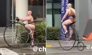 Seattle's Eccentric Penny-Farthing Rider in Leopard Print Leotard