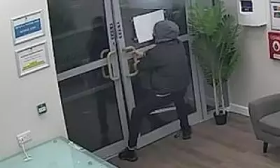 Bungling burglar caught on CCTV struggling with locked doors after theft