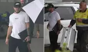 Billionaire Adrian Portelli flies out of Gold Coast with staff carrying his luggage