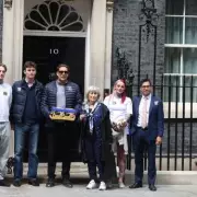 Children of British Couple Held in Iran Hand Petition at Downing Street