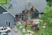 Man Uses Excavator to Demolish Home with Family Inside