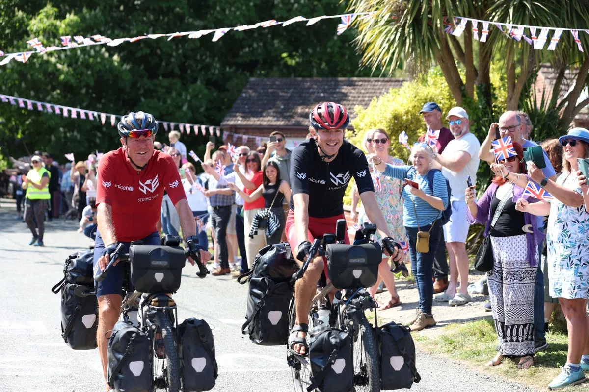 Father and son set three world records after round-the-world charity cycle