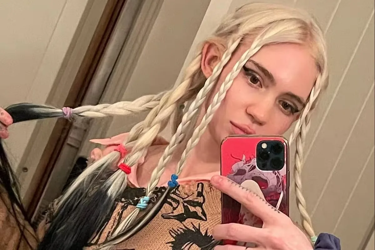 Grimes Sparks Elf Ear Surgery Rumours with Bandaged Selfie