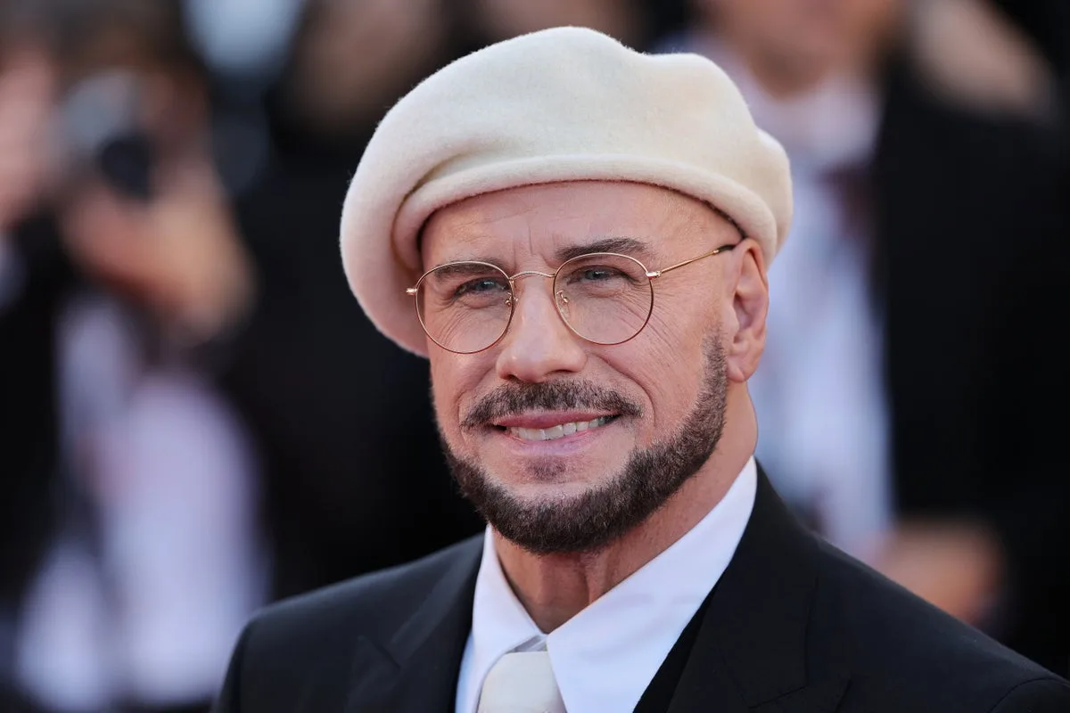 John Travolta Explains Cannes Beret and Glasses Look