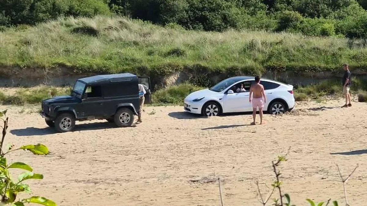 Tesla Driver Branded 'Moron' After Parking on Cornwall Beach and Swearing at Locals