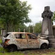 Burnt-out car driven into gravestone at Glasgow cemetery sparks outrage