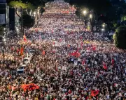 Global Photos: Protests, Dolphins, and World Cup Countdown