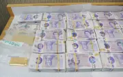 Moment police raid East London money store seizing £2.5m cash and gold