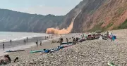 Cliff collapses onto Devon beach metres from tourists