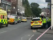 Emergency services swarm Middleton town centre in stand off with man on roof