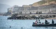 Fires and clashes as 3,000 migrants storm Spain-Morocco border