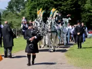 Hundreds Bid Farewell to 'Dickybird' with Irish Flags and Horse-Drawn Hearse
