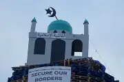 Loyalist bonfire lit early as police move to remove mosque replica