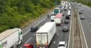 M25 chaos as lorry crashes into field causing 60-minute delays