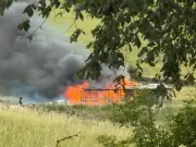 Murder probe after woman found dead in Rochdale farm fire