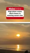 Plane Flies Over Welsh Beach at Sunset in Stunning Video