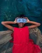 Soumayan Biswas Captures Girl Absorbed in Phone Amid Fishing Nets