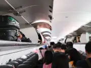 Travel Writer Warns: Standing in Plane Aisle Before Doors Open Is Dangerous
