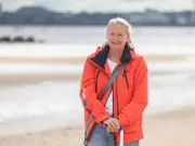 Triathlete Rescued by RNLI Lifeguard Rivals in Rough Seas