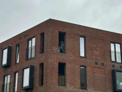 Man critical after balcony fall in Salford; suspect quizzed