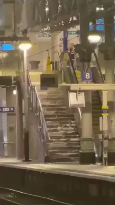 Rain gushes down stairs at Manchester Piccadilly during storm