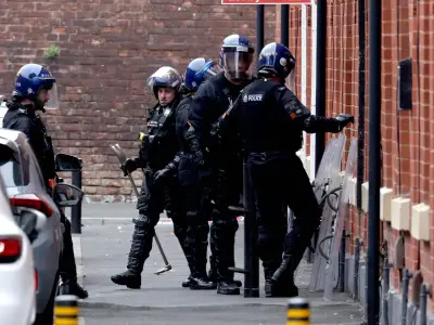 Riot police in Salford as man's 36-hour rooftop stand-off continues