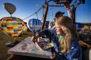 Artist Emily Powell paints from hot air balloon at Bristol fiesta