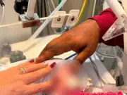 Baby found alive in body bag returns home after 'miracle'