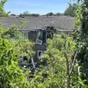Car crashes into top floor of house in Kent, woman arrested