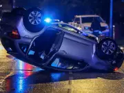 Car flips onto roof after crash with milk float in Denton