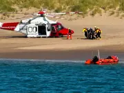 Coastguard helicopter and lifeboats rescue woman on Caldey