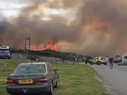 Crews battle fire near Scots caravan park for second day