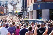 Crowd sings Bonnie Tyler hit as coffin returns to Swansea