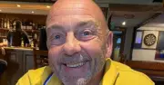 Dad in tears as he's charged with manslaughter after dog bite death