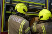 Dozens of firefighters tackle huge grass fire in outer London