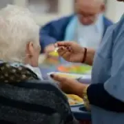 Elderly woman fed dog food by carer before death