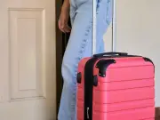 Flight attendant's suitcase tip stops noisy wheels and keeps luggage clean