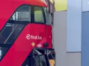 London double-decker bus hits pedestrian and crashes into building