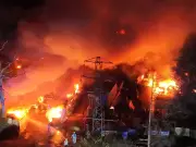 Man arrested after huge fire destroys cars at Gatwick holiday parking site