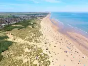 Man dies at Camber Sands as two escape water